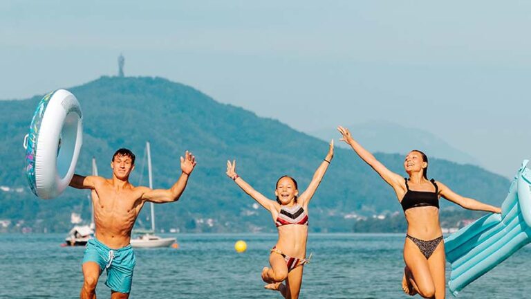 Kinder springen mit Freude in den Wörthersee im Strandbad Klagenfurt